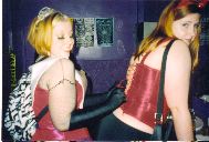 Gwenhwyfar getting her corset tied in the bathroom